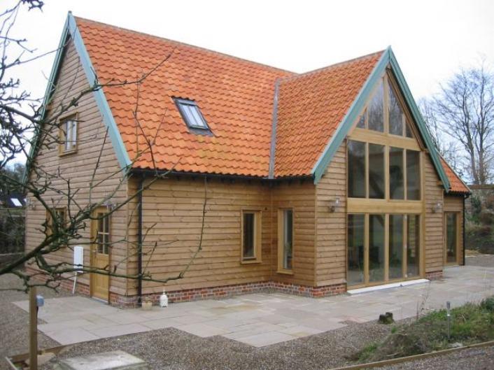 Oak framed house with direct glazing and oak weatherboarding.