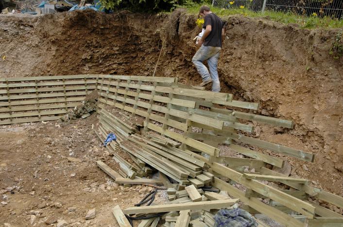 A timber lattice being constructed for use as a retaining wall.
