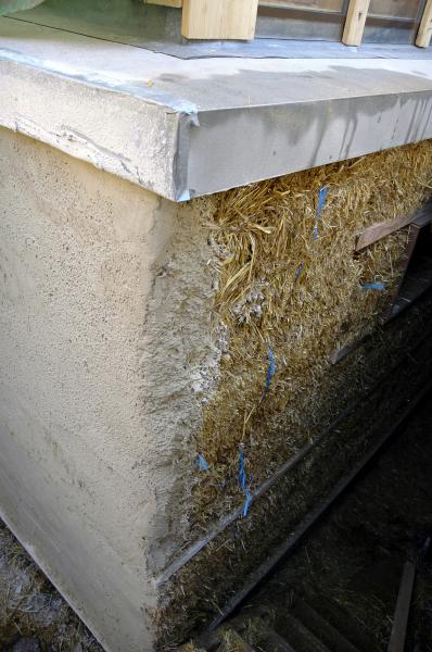 Lime render being applied to a straw bale wall.