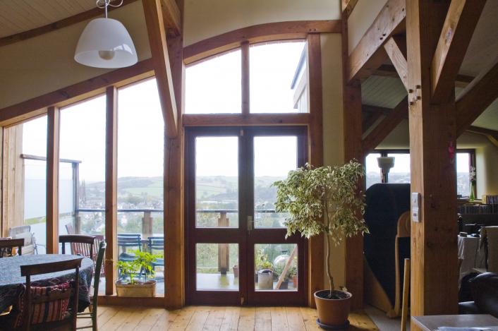 A feature window within the living space of a timber framed straw bale house.