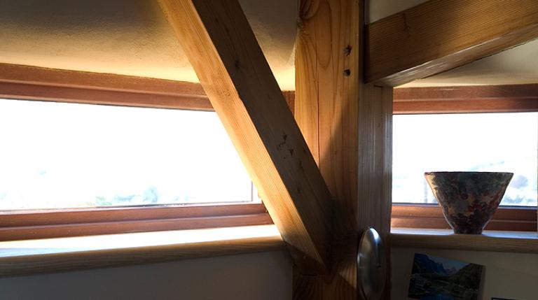 Douglas fir beams in front of a window.
