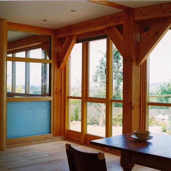 Planed and oiled Douglas fir beams in a modern dining room.