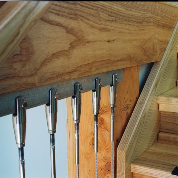 Stainless steel stair rods and Douglas fir beams.