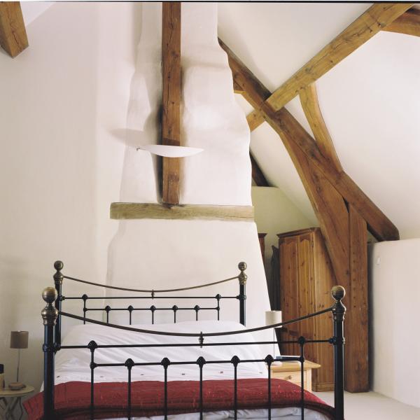Oak frame roof provides quirky bedroom.