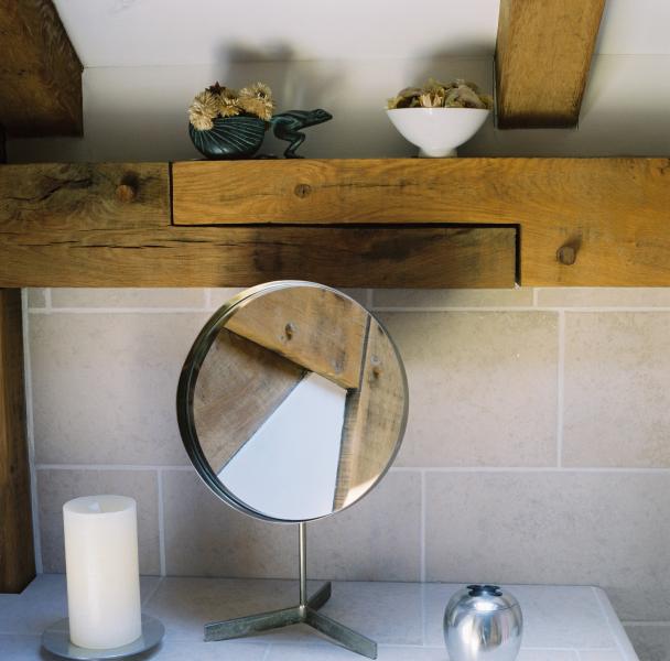 Shaving mirror, candle and oak beams.