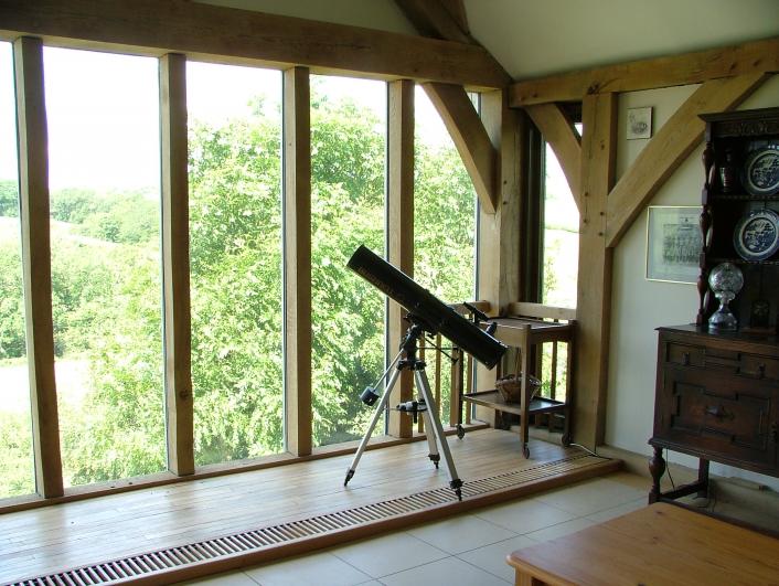 Telescope in front of a direct glazed oak frame.