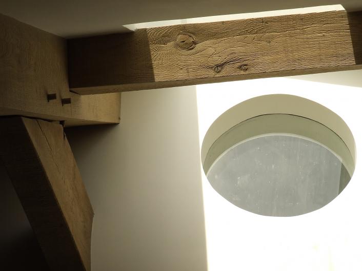 Oak beams and a round window.