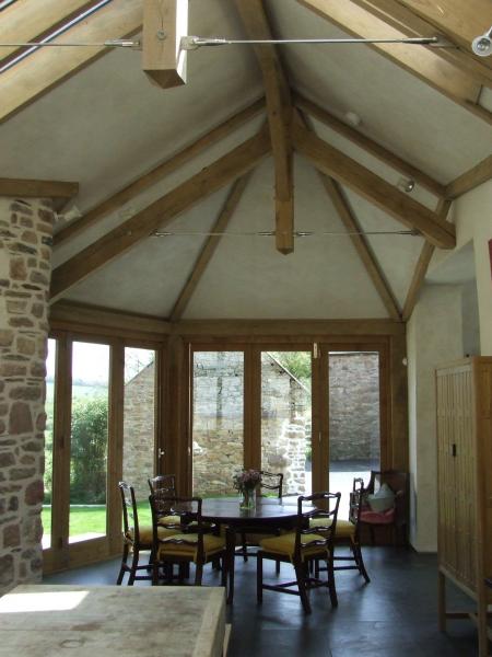 Open plan kitchen under exposed contemporary oak roof.
