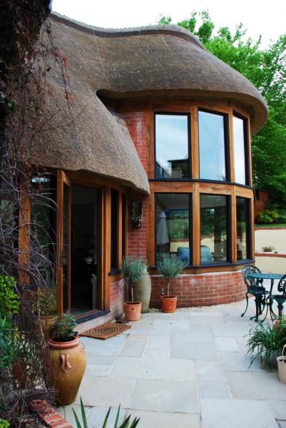 Patio garden next to a modern thatched extension.