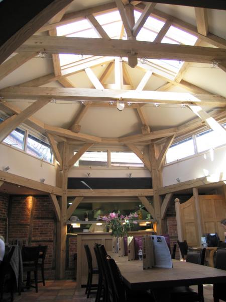Hexagonal oak frame roof providing restaurant extension.