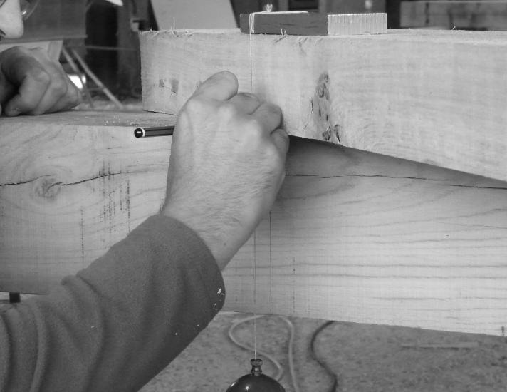 Traditional carpentry using a plumb bob.