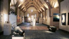 An exhibition under the oak roof at Place Barton Barn.