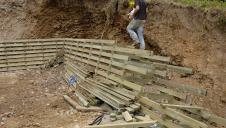 A timber lattice being constructed for use as a retaining wall.