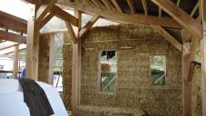 An almost finished straw bale wall.