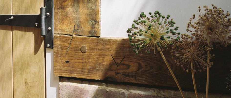 Uncleaned oak beam showing carpenter's mark.