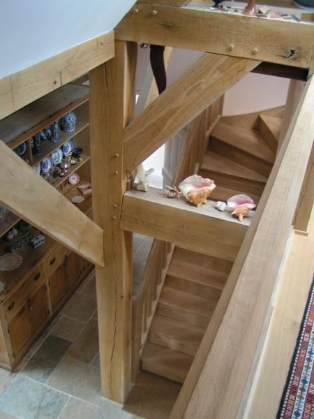 The stairwell of an oak framed house.