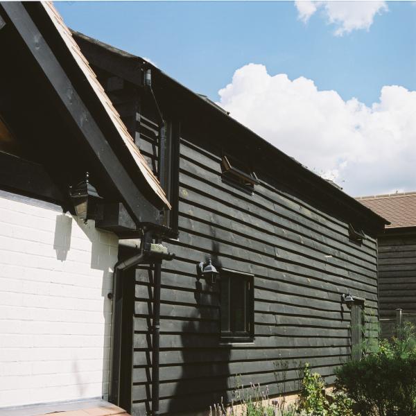 Traditional external weatherboarding on an oak framed barn.