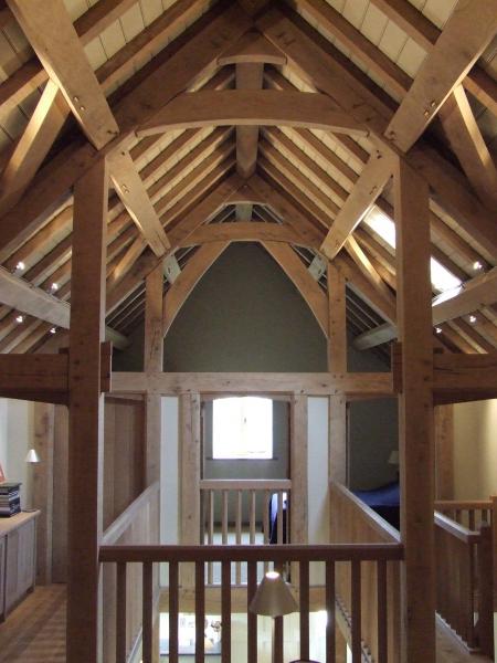 A gallaried stairwell with exposed oak roof.
