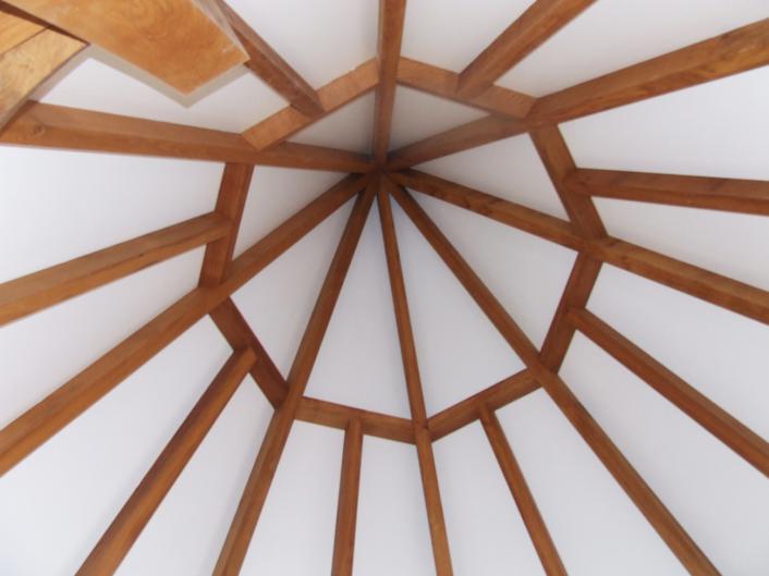 Inside the apex of a timber frame spire.